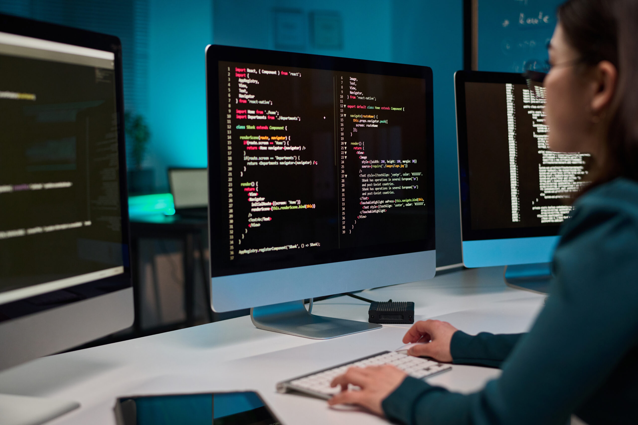 Computer with Code Lines on Screen and Girl Typing