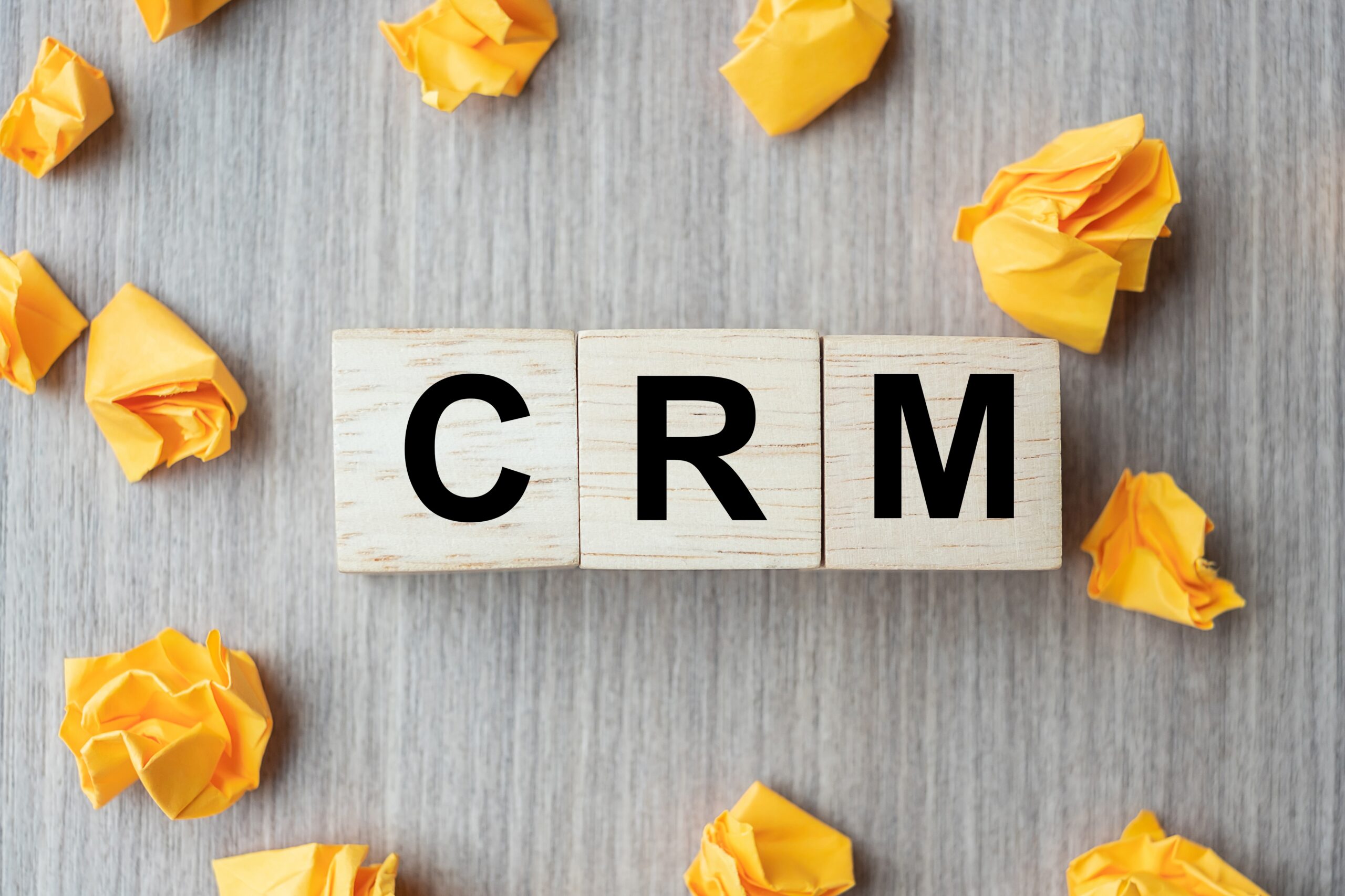 wooden cube with CRM text (Customer Relationship Management) and