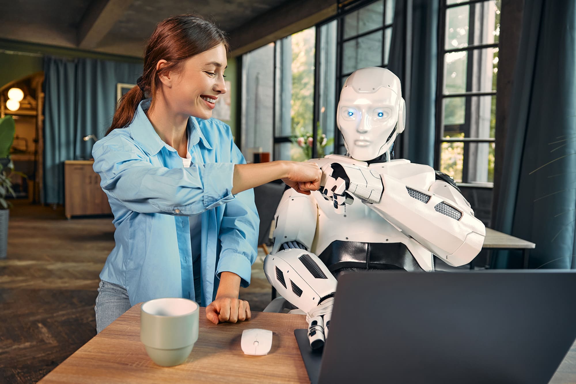 robot-and-woman-working-on-laptop-in-office-2025-03-26-21-04-48-utc